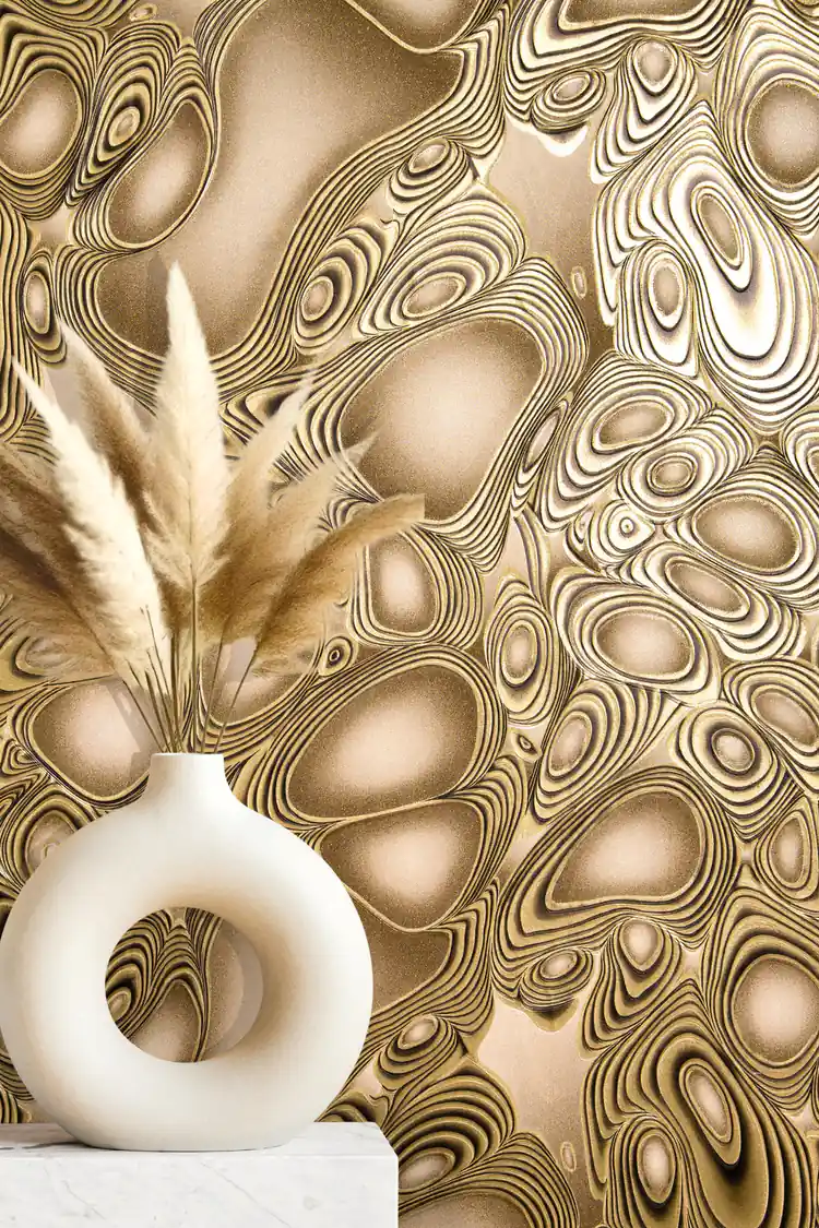 Styled vignette of gold molten flow wallpaper with a round white vase and pampas grass