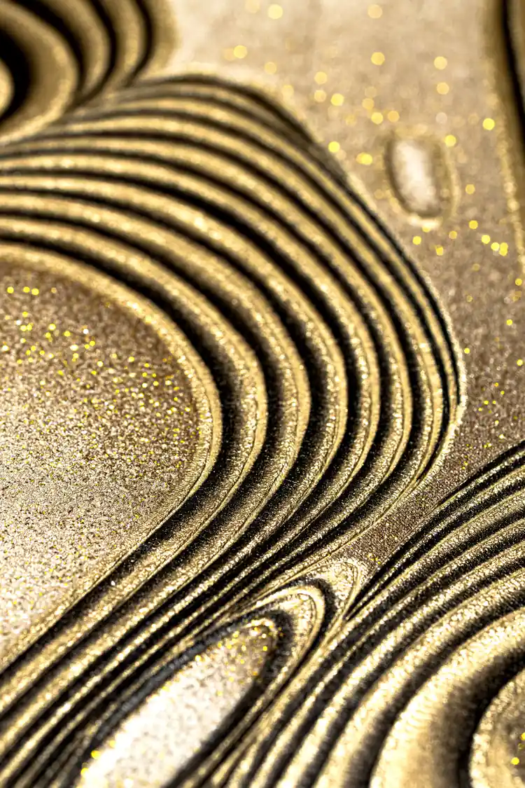 Extreme macro of golden glitter-coated swirling ridges on the bronze metallic wallpaper surface