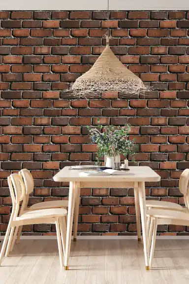 Dining room scene with red brick wallpaper behind a wooden table, chairs, and woven pendant lamp