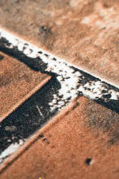 Extreme macro of textured brick and white mortar joint detail on the rustic red wallpaper