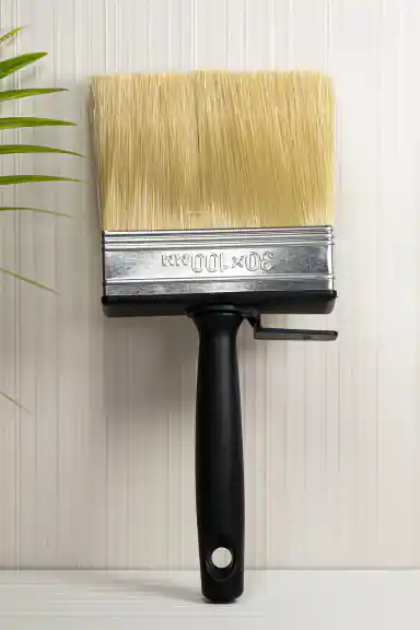 Wide 30x100mm wallpaper paste brush with natural bristles and black handle on white background