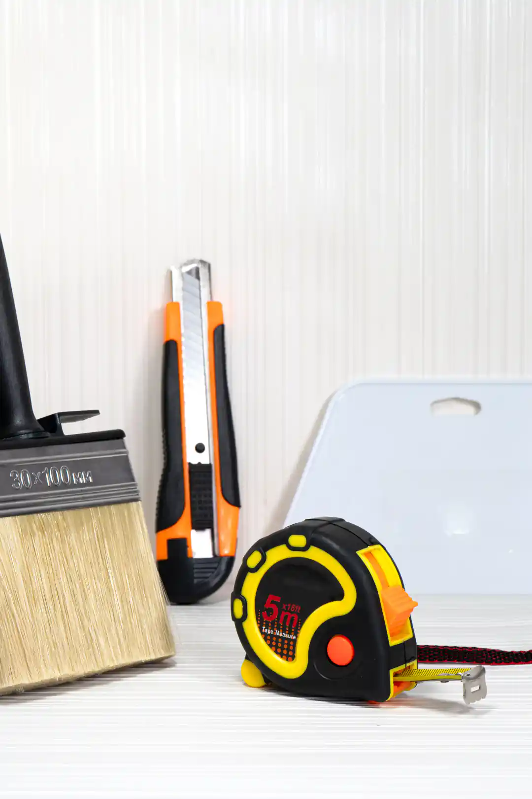 Wallpaper installation tool kit with paste brush, utility knife, squeegee, and measuring tape