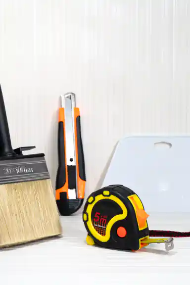 Wallpaper installation tool kit with paste brush, utility knife, squeegee, and measuring tape