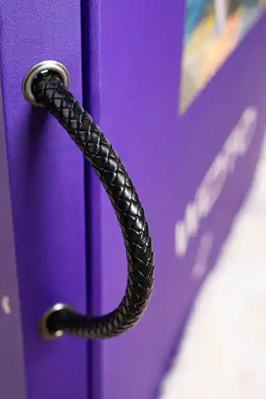 Close-up of braided black leather handle on the purple WOTO 1 sample book spine