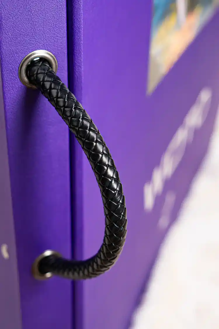 Close-up of braided black leather handle on the purple WOTO 1 sample book spine